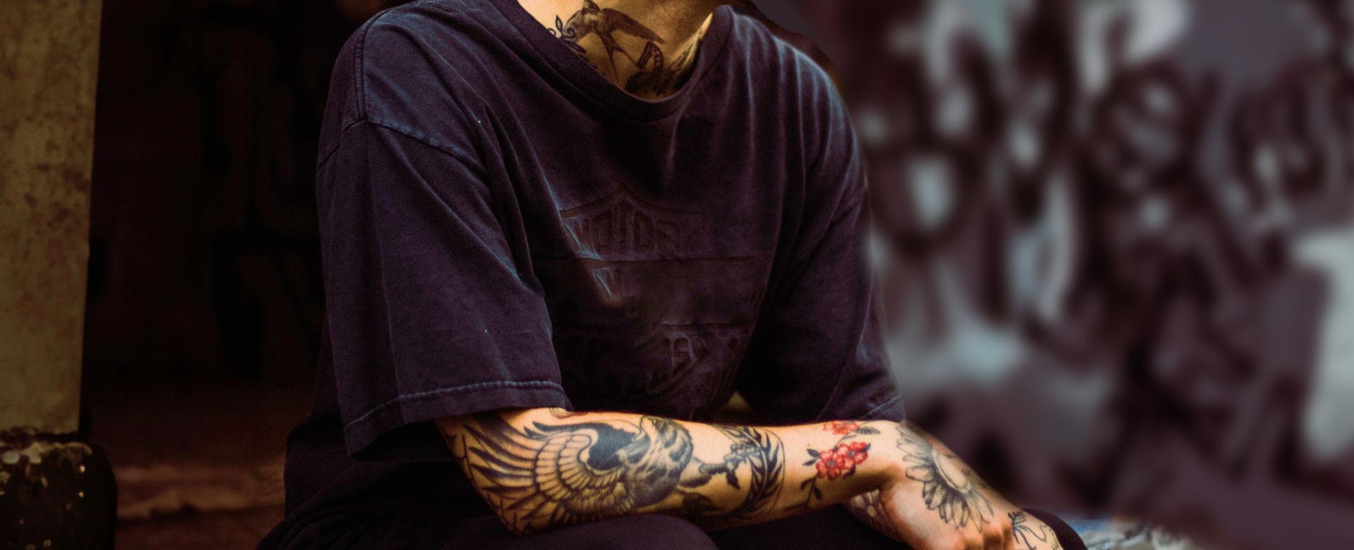 Man with Tattooed Arm and Neck Wearing a T-shirt