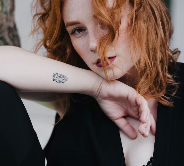 Woman with a Tattoo on her Arm Woman with a Tattoo on her Arm